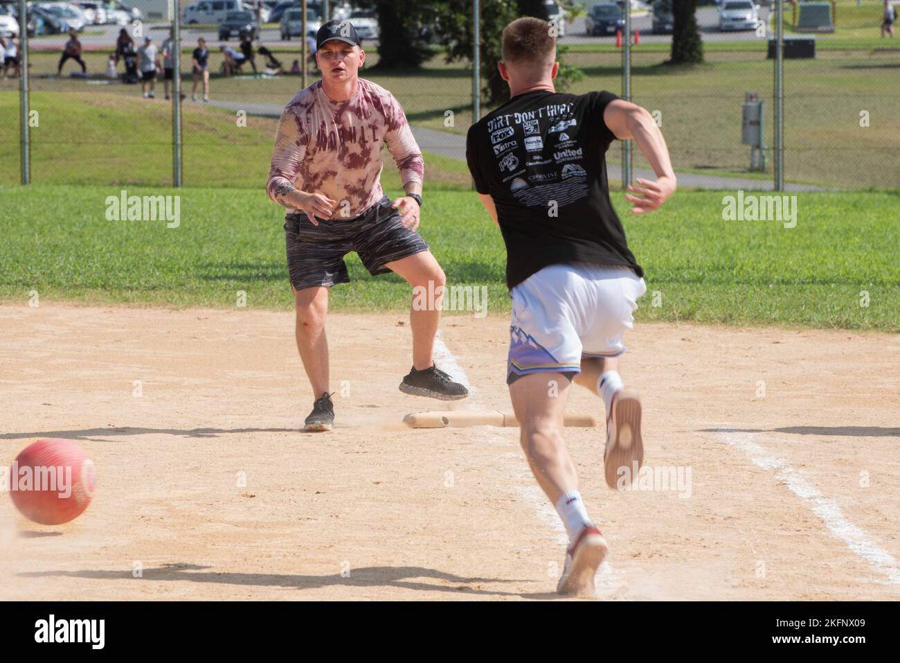An Airman waits for the ball to reach him on first base during the
