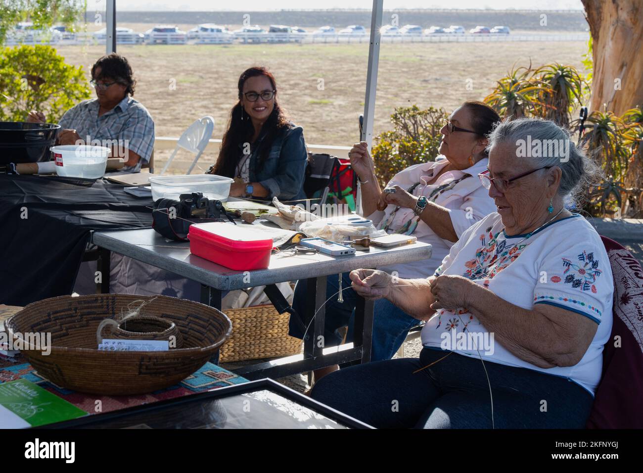 Members of the California Indian Basketweavers’ Association weave baskets during a celebration