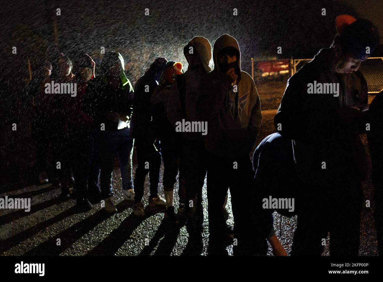 Youth migrants from Central and South America, traveling without adults, endure cold wet weather as they await to be registered by border patrol agents after being smuggled across the Rio Grande river from Mexico into Roma, Texas, U.S., November 18, 2022.  REUTERS/Adrees Latif Stock Photo
