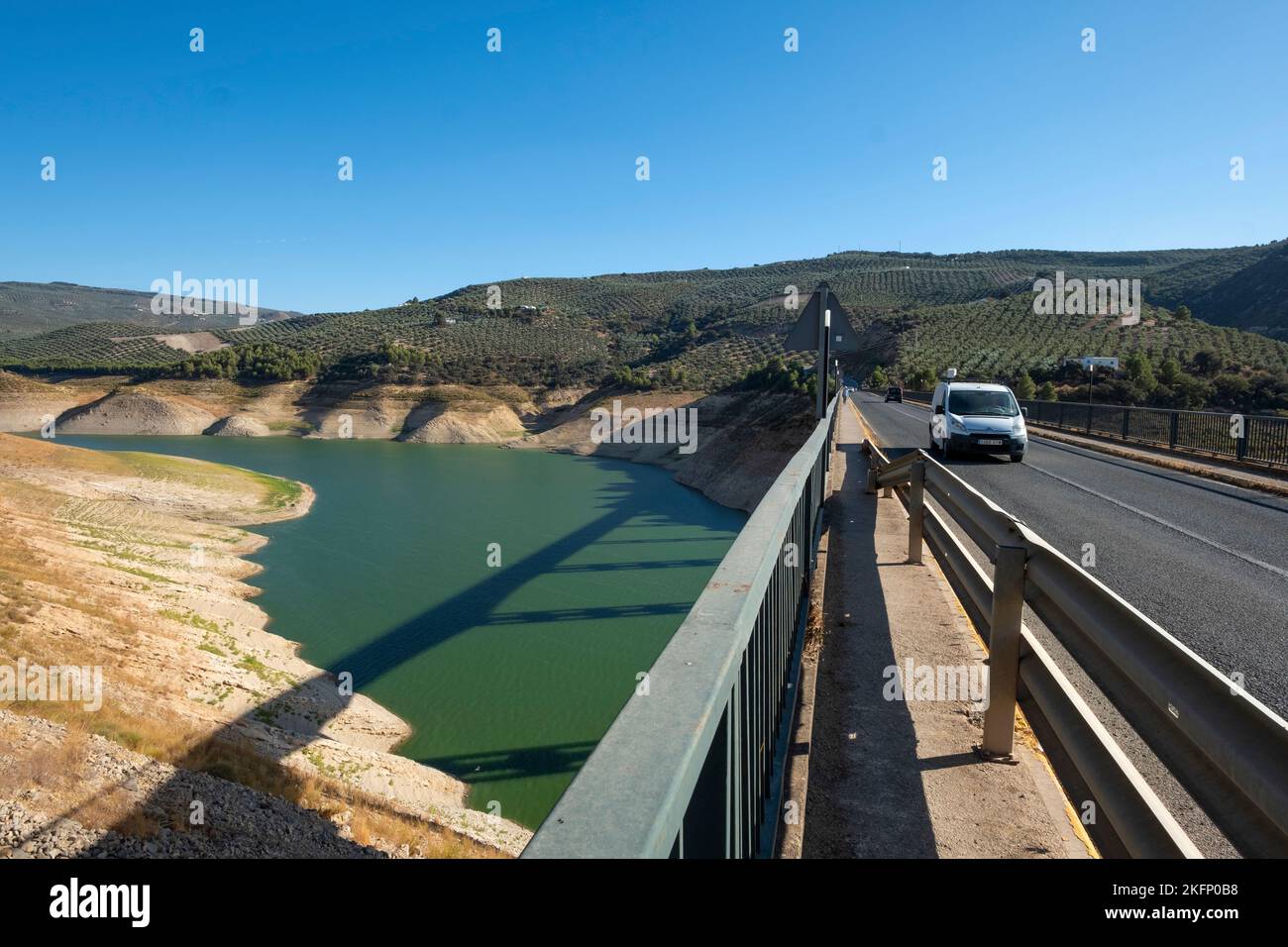 Drought conditions showing 15% water level in Iznajar Embalse, the largest reservoir in Andalucia, from Iznajar bridge, southern Spain Stock Photo