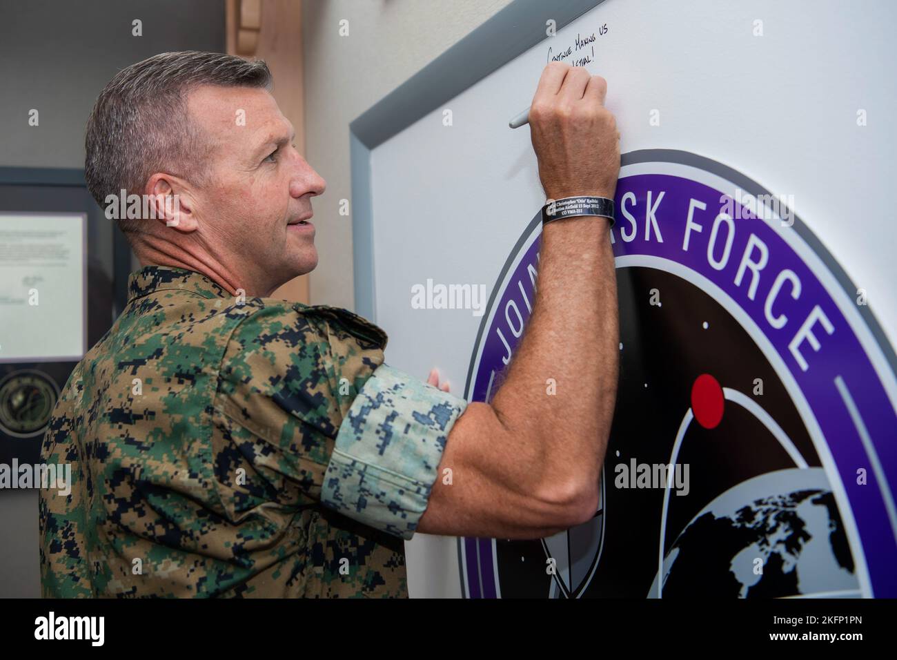 U.S. Marine Corps Brig. Gen. Simon Doran, director of Strategy and Plans Division, Headquarters Marine Corps, signs the Joint Task Force-Space Defense heritage board during his visit to the organization at Schriever Space Force Base, Colorado, Sept. 29, 2022. Doran received a mission brief from U.S. Army Maj. Gen. Tom James, commander of the JTF-SD. The JTF-SD, in unified action with mission partners, deters aggression, defends capabilities, and defeats adversaries throughout the continuum of conflict. Stock Photo