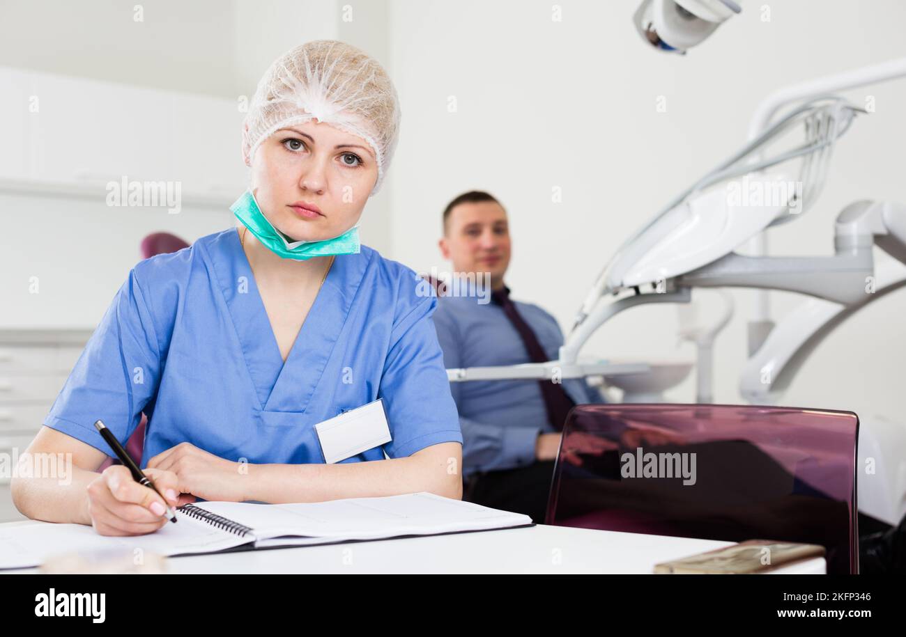 Female dentist working with medical records Stock Photo Alamy