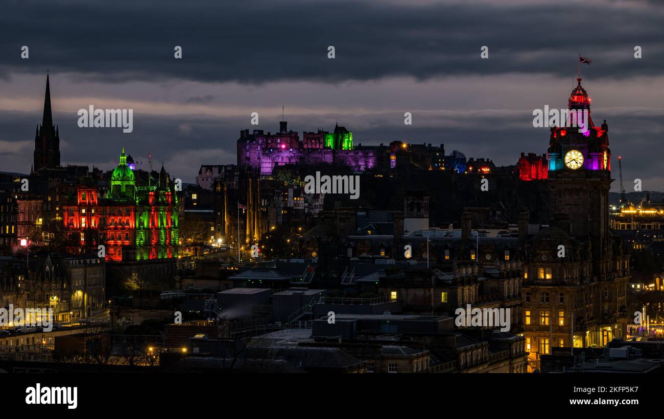 Edinburgh, Scotland, UK, 19th November 2022. Castle of Light: the annual Christmas light show at Edinburgh Castle lights up the city skyline at night with the Balmoral Hotel clock tower and the HBoS bank headquarters on The Mound also lit up in colourful lights. Credit: Sally Anderson/Alamy Live News Stock Photo