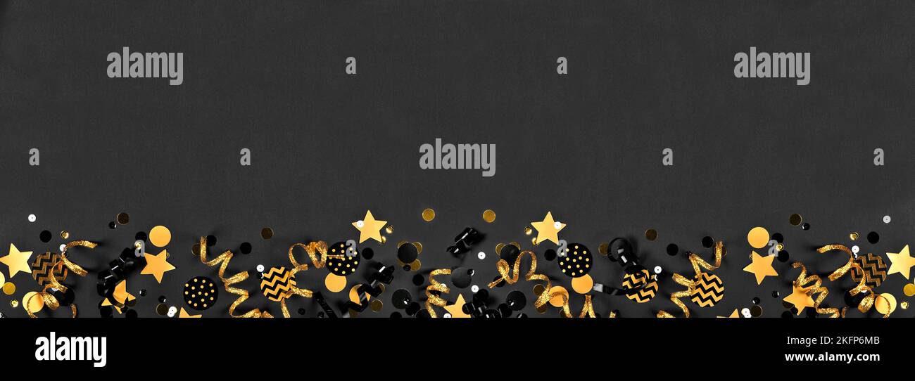 New Years party bottom border with glittery black and gold streamers ...