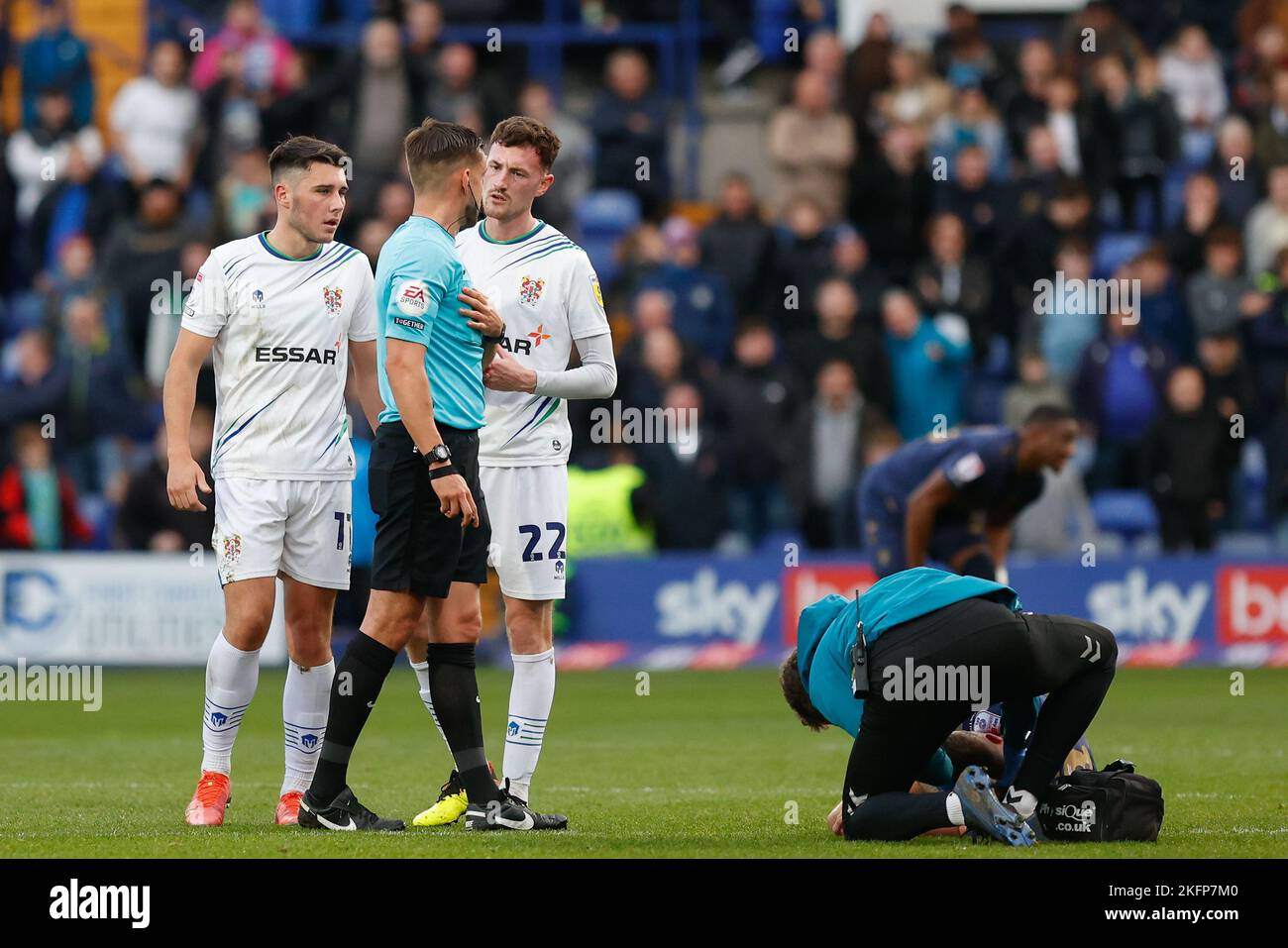Josh Hawkes #11 and Paul Lewis #22 of Tranmere Rovers talk with referee Thomas Kirk during the Sky Bet League 2 match Tranmere Rovers vs AFC Wimbledon at Prenton Park, Birkenhead, United Kingdom, 19th November 2022  (Photo by Phil Bryan/News Images) Stock Photo