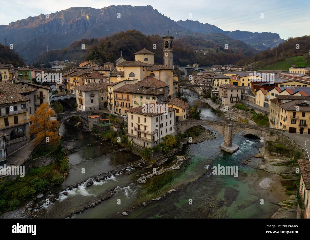 Aerial view of ancient church and crossing rivers surrounded by Alps mountains, San Giovanni Bianco Village, Valbrembana, Bergamo, Lombardy, Italy Stock Photo