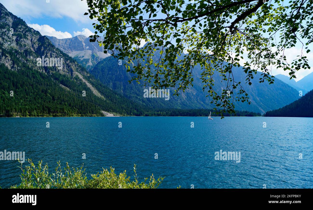 turquoise alpine lake Plansee in the scenic Austrian Alps on a sunny ...