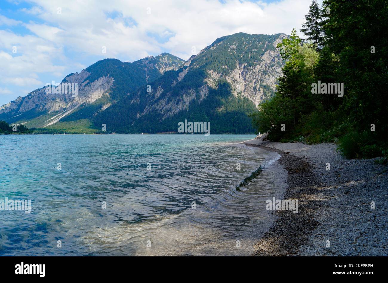 turquoise alpine lake Plansee in the scenic Austrian Alps on a sunny ...