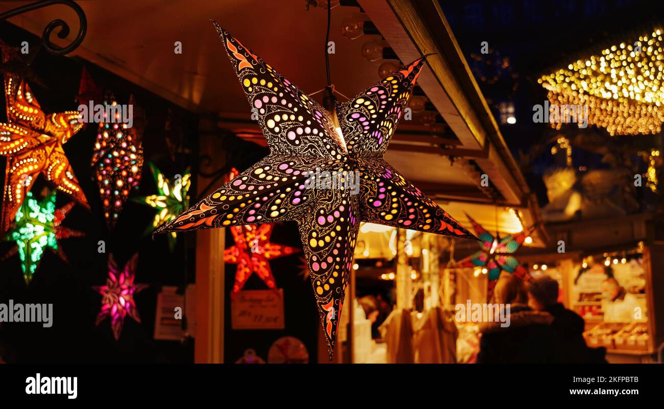 Beautiful Christmas stars being sold at a Christmas market stand in downtown Düsseldorf/Germany. Stock Photo