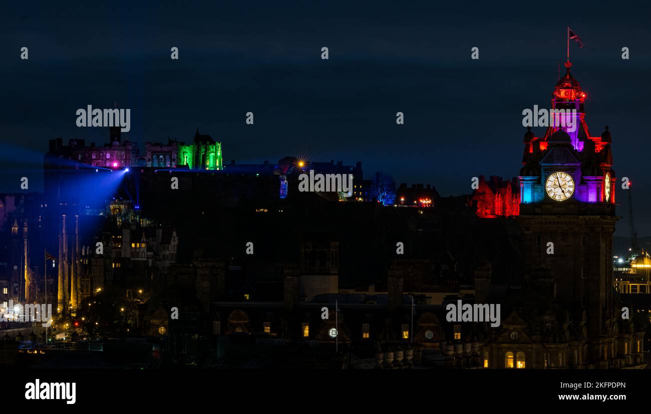 Edinburgh castle and Balmoral Hotel clock tower lit up at night during Castle of Light event Scotland, UK Stock Photo