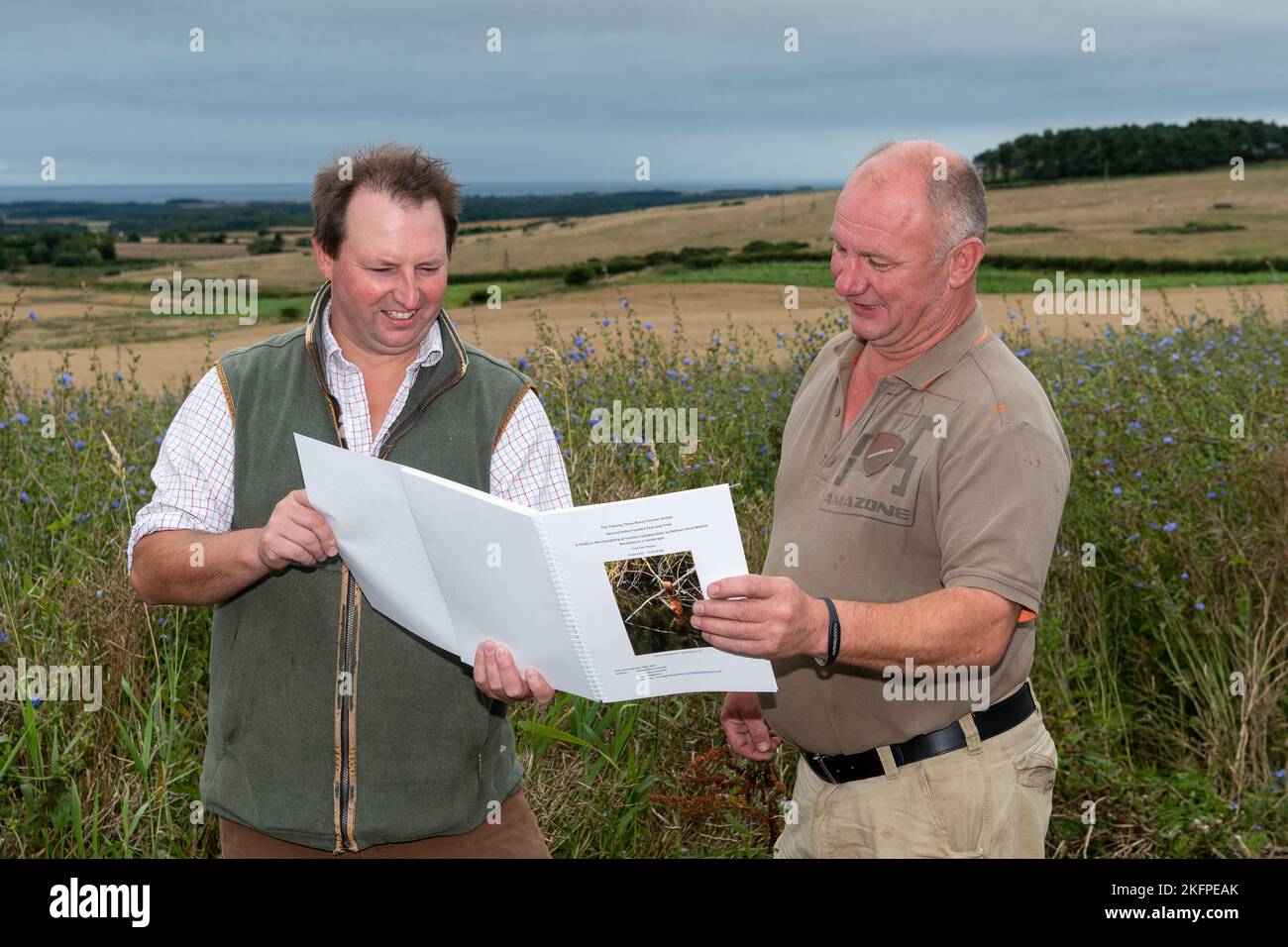 Land agent and farmer discussing farm management on an arable farm in