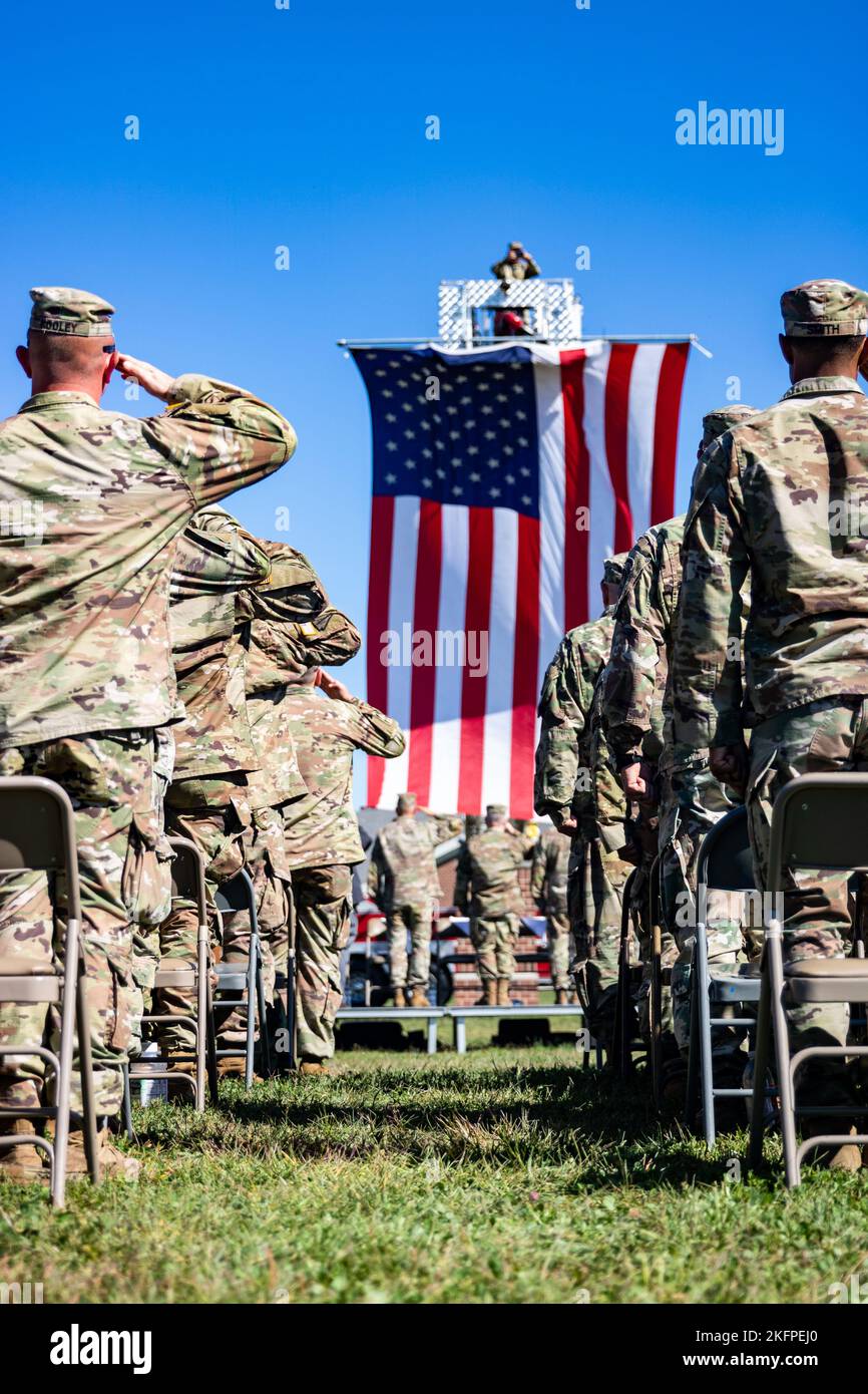 Soldiers with the 76th Infantry Brigade Combat Team salute the U.S. flag during the national anthem during their departure ceremony at Camp Atterbury near Edinburgh, Friday, Sept. 30, 2022. Stock Photo