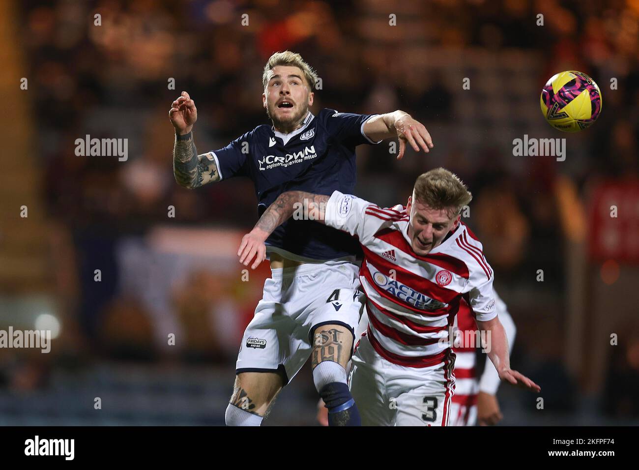 19th November 2022; Dens Park, Dundee, Scotland: Scottish Championship Football, Dundee versus Hamilton Academical; Tyler French of Dundee heads clear from Matthew Shiels of Hamilton Academical Stock Photo