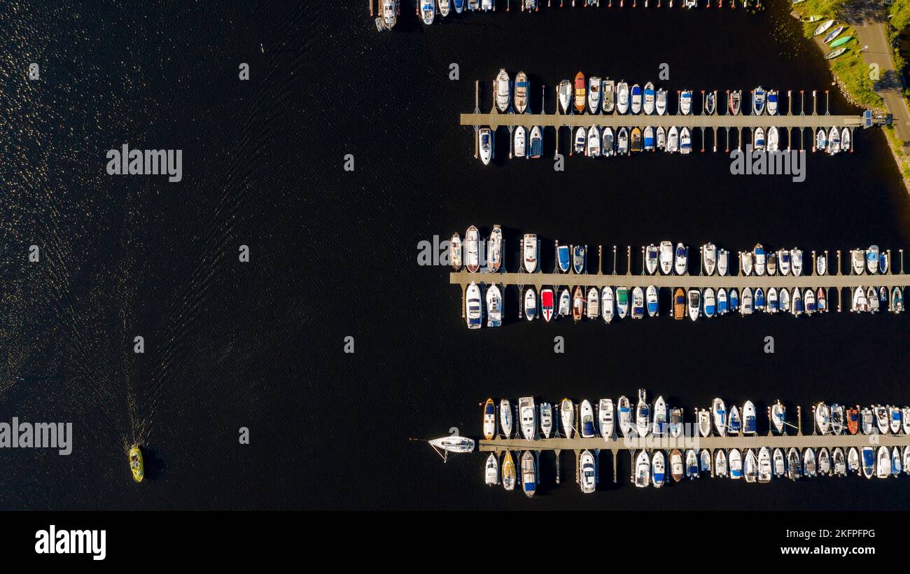 Aerial View by Drone of Yacht Club and Marina. Top view of yacht club. White boats in sea water. Marina dock yachts and small motor boats. Yacht and s Stock Photo