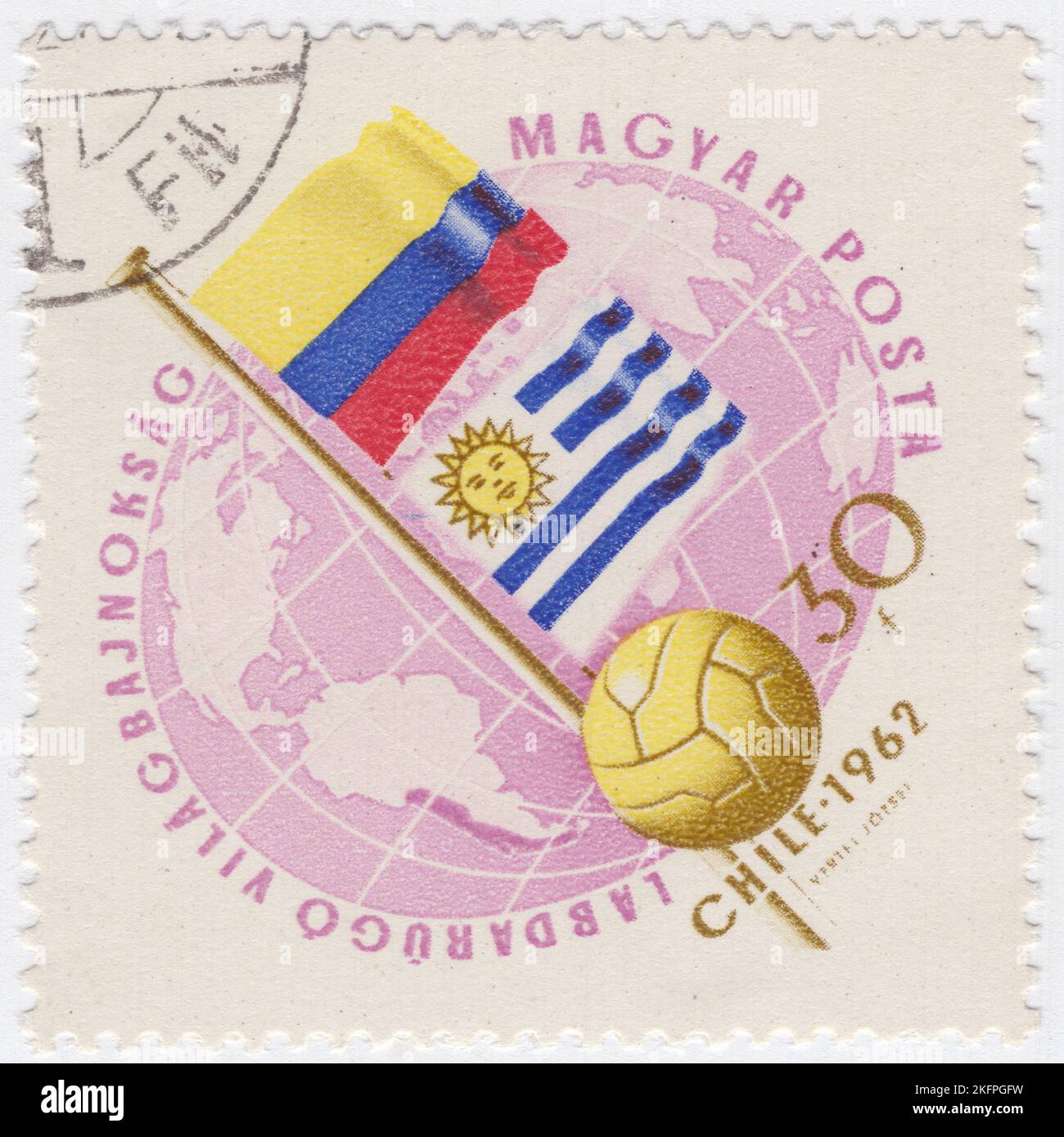 HUNGARY - 1962 May 21: An 30 forints rose and bister postage stamp depicting Globe, Soccer Ball and Flags of Colombia and Uruguay. Flags in National  Colors. World Cup Soccer Championship, Chile, May 30...June 17. A total of 56 teams entered the 1962 FIFA World Cup qualification rounds, competing for a total of 16 spots in the final tournament. Chile, as the hosts, and Brazil, as the defending champions, qualified automatically, leaving 14 spots open for competition Stock Photo