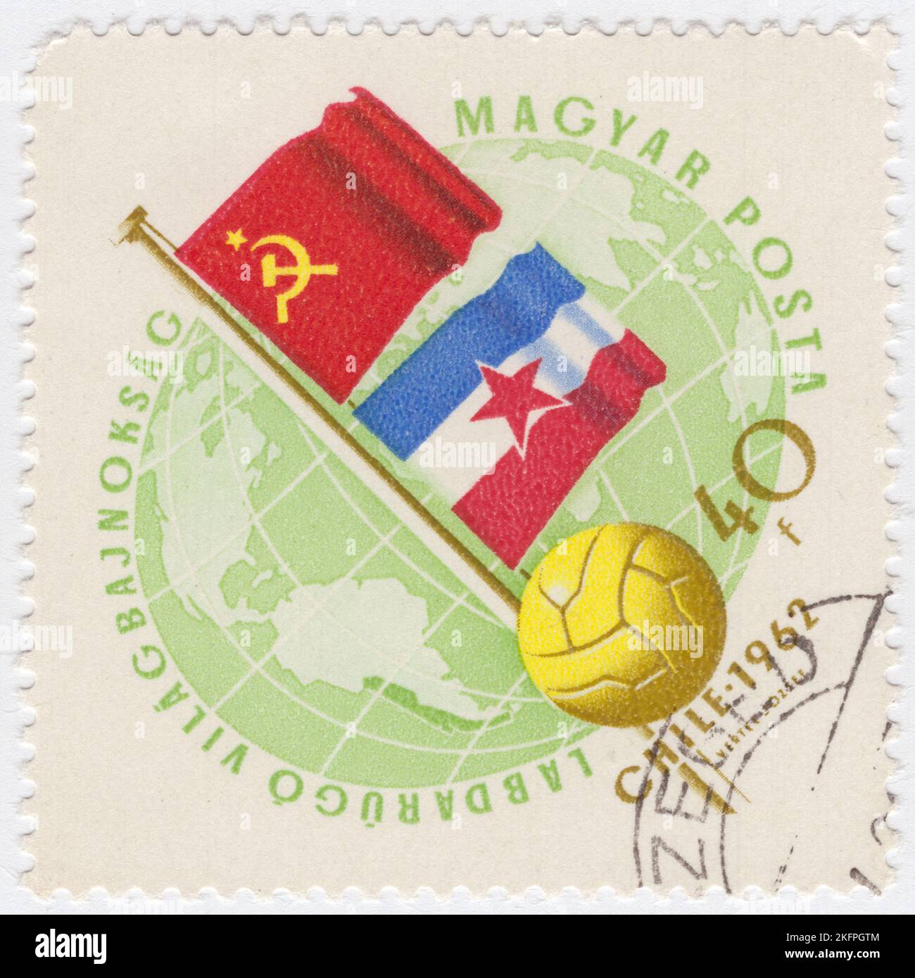 HUNGARY - 1962 May 21: An 40 forints pale green and bister postage stamp depicting Globe, Soccer Ball and Flags of USSR and Yugoslavia. Flags in National  Colors. World Cup Soccer Championship, Chile, May 30...June 17. A total of 56 teams entered the 1962 FIFA World Cup qualification rounds, competing for a total of 16 spots in the final tournament. Chile, as the hosts, and Brazil, as the defending champions, qualified automatically, leaving 14 spots open for competition Stock Photo
