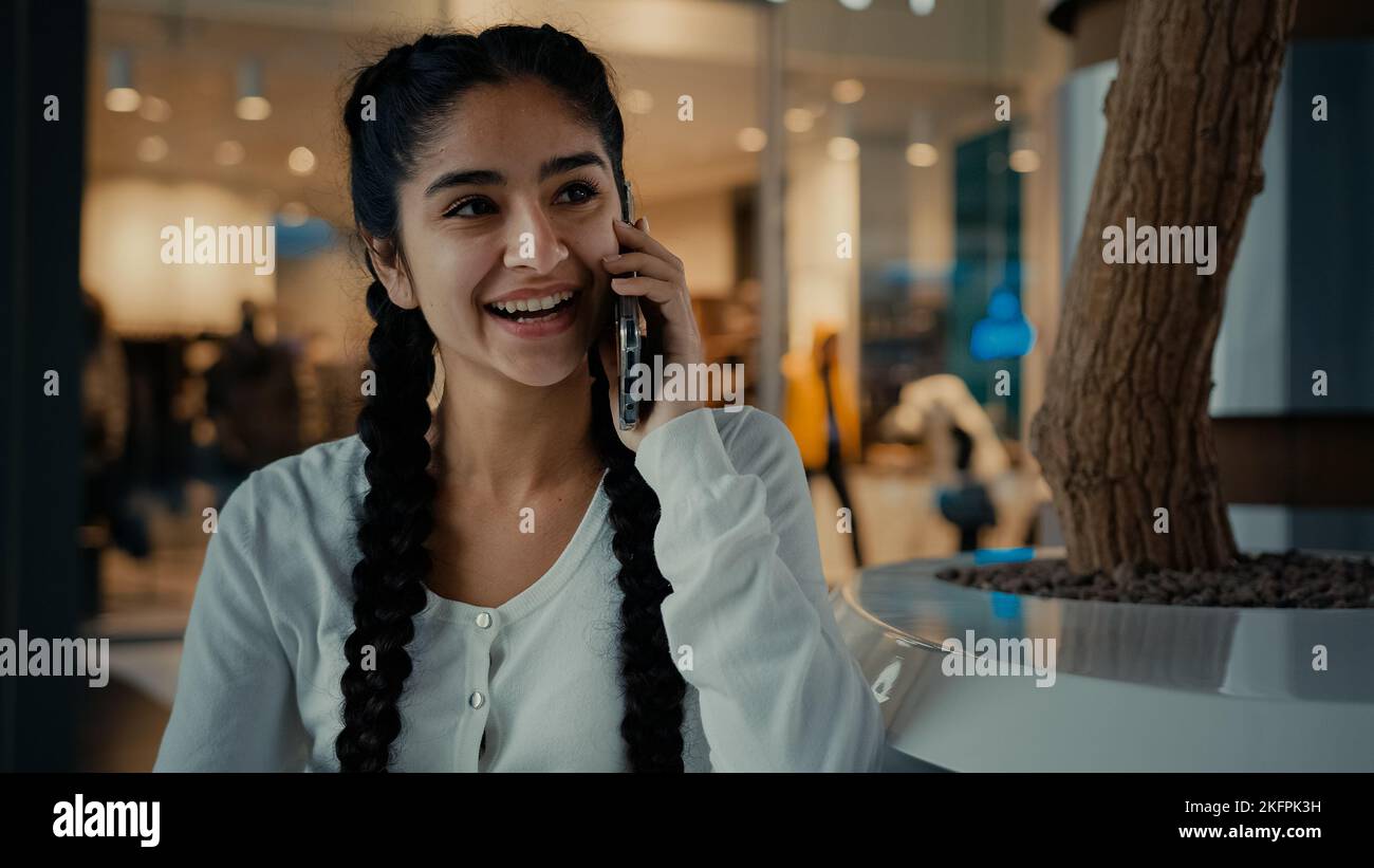 Smiling arabian middle-eastern woman buyer customer student businesswoman ethnic girl lady spend weekend at shopping mall business center answer Stock Photo