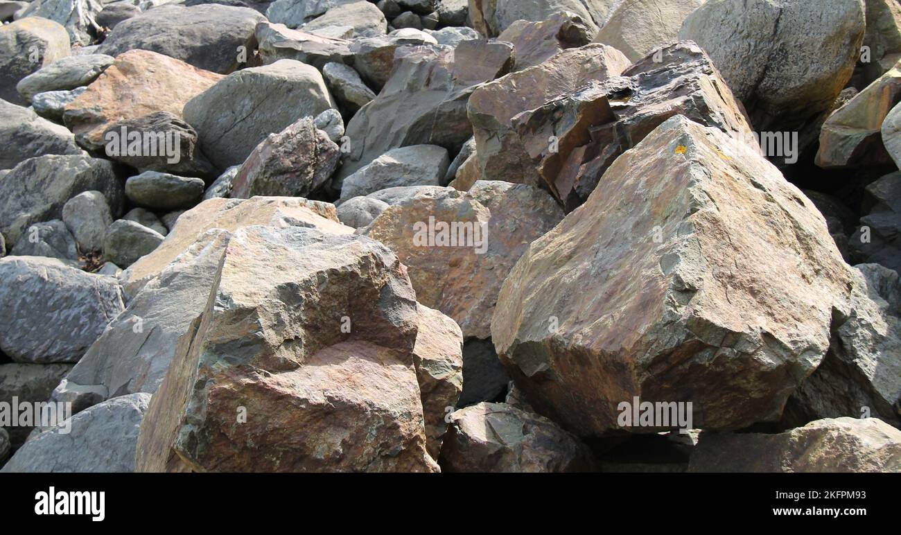 Large Rocks at the Edge of a Seaside Beach Stock Photo - Alamy