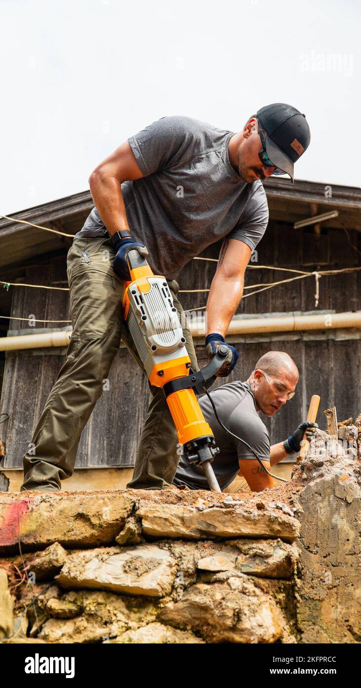 U.S. Air Force Tech Sgt. Cameron Farrell, Explosive Ordnance Disposal (EOD)  technician, a Short Term Independent Augmentee (STIA) with the Defense  POW/MIA Accounting Agency (DPAA), utilizes a specialized demolition hammer  to break