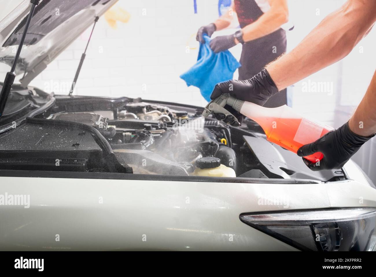 Car detailing maintenance, cleaning engine with the foam and a brush Stock Photo