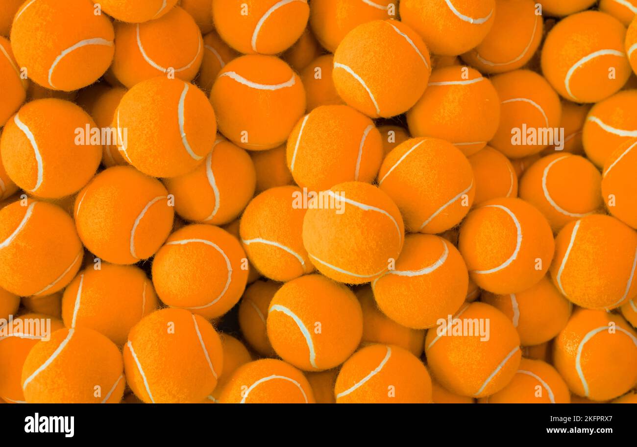 Lots of vibrant tennis balls, pattern of new orange tennis balls for