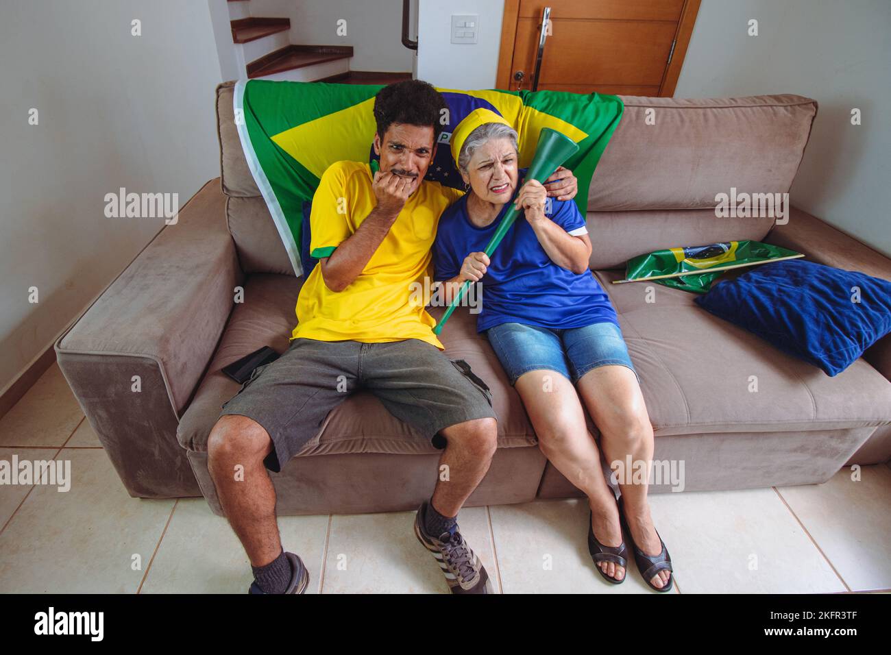 Mother and Son Celebrating the Cup in the living room watching TV