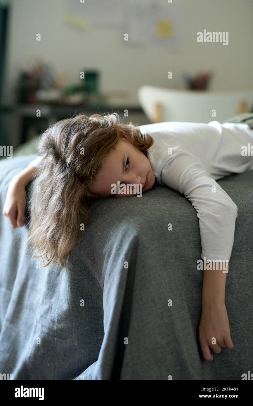 Tired little boy lying on bed in bedroom without mood or he feeling sick Stock Photo Alamy