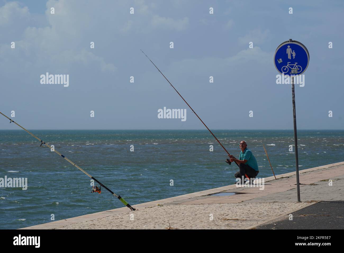 Lisbon, Portugal- September 2022: Angler fishing on the river Tagus in Portugal Stock Photo
