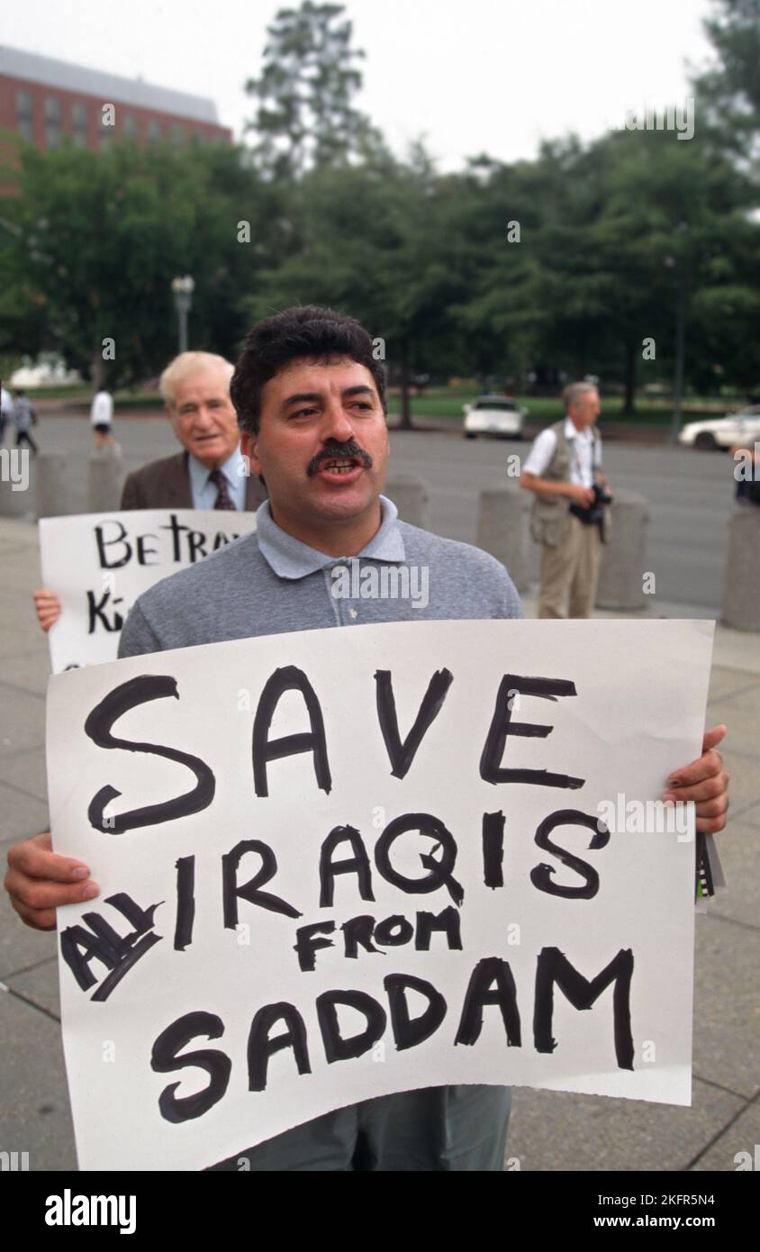 Protesters walk with signs demanding action against Iraqi leader Saddam Hussein to protect the Kurds outside the White House, August 30, 1996 in Washington, D.C. The Iraqi leader sent troops into Kurdistan killing hundreds of U.S backed rebels. Stock Photo