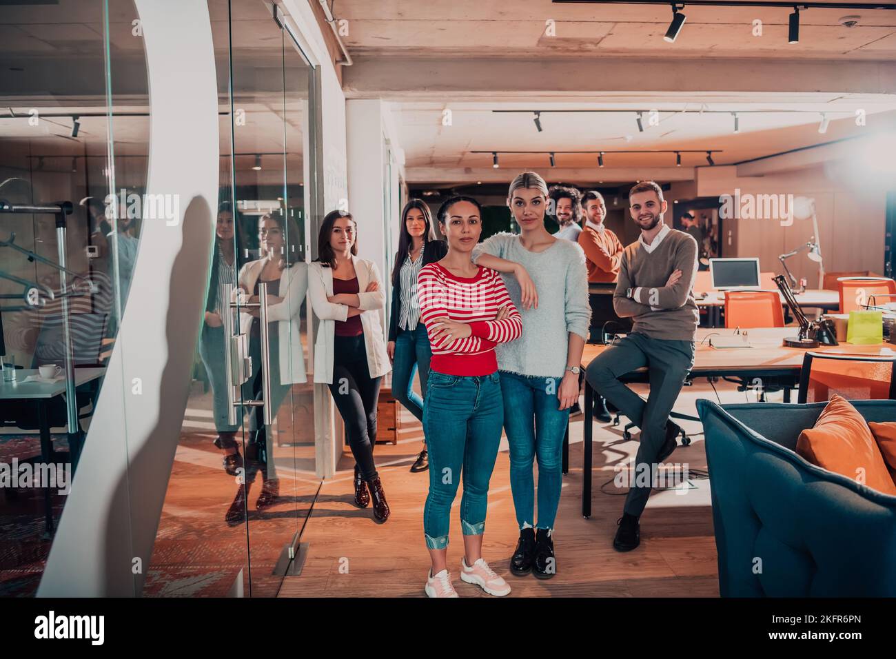 A diverse group of successful business people in a modern glass office ...