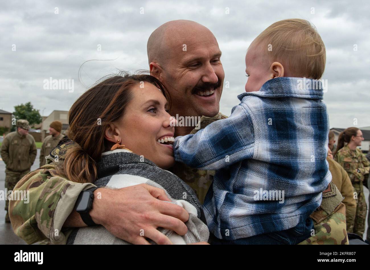 Capt. Ben Bertelson, center, 3rd Airlift Squadron C-17 Globemaster III pilot, hugs his wife Amanda and son Beau upon returning to Dover Air Force Base, Delaware, Oct. 3, 2022. Members from the 3rd AS, 436th Mission Generation Group and 436th Security Forces Squadron were greeted by family, fellow squadron and Team Dover members after a deployment to Al Udeid Air Base, Qatar. Stock Photo