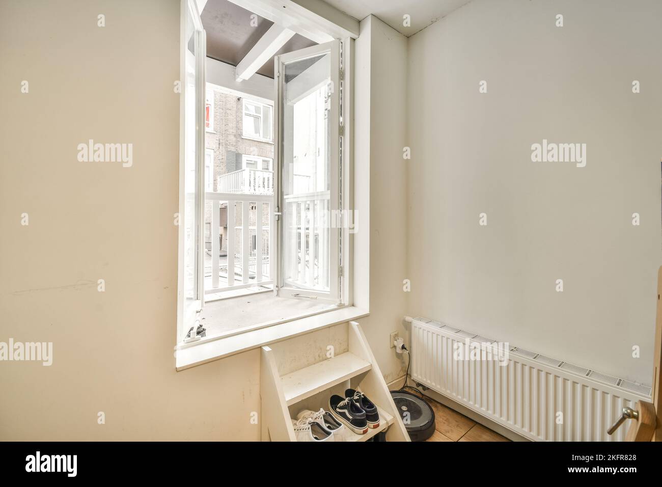 Sofa located near lounge area and open kitchen in spacious room of