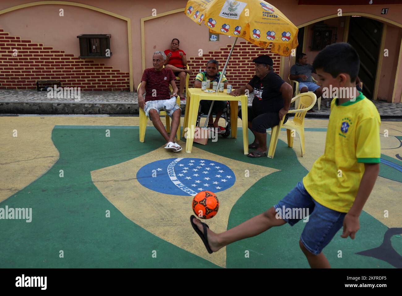 A boy plays soccer along the Third Street of the Alvorada neighbourhood which is decorated for the upcoming 2022 FIFA World Cup Qatar, in Manaus, Amazonas state, Brazil November 19, 2022. REUTERS/ Bruno Kelly     TPX IMAGES OF THE DAY Stock Photo
