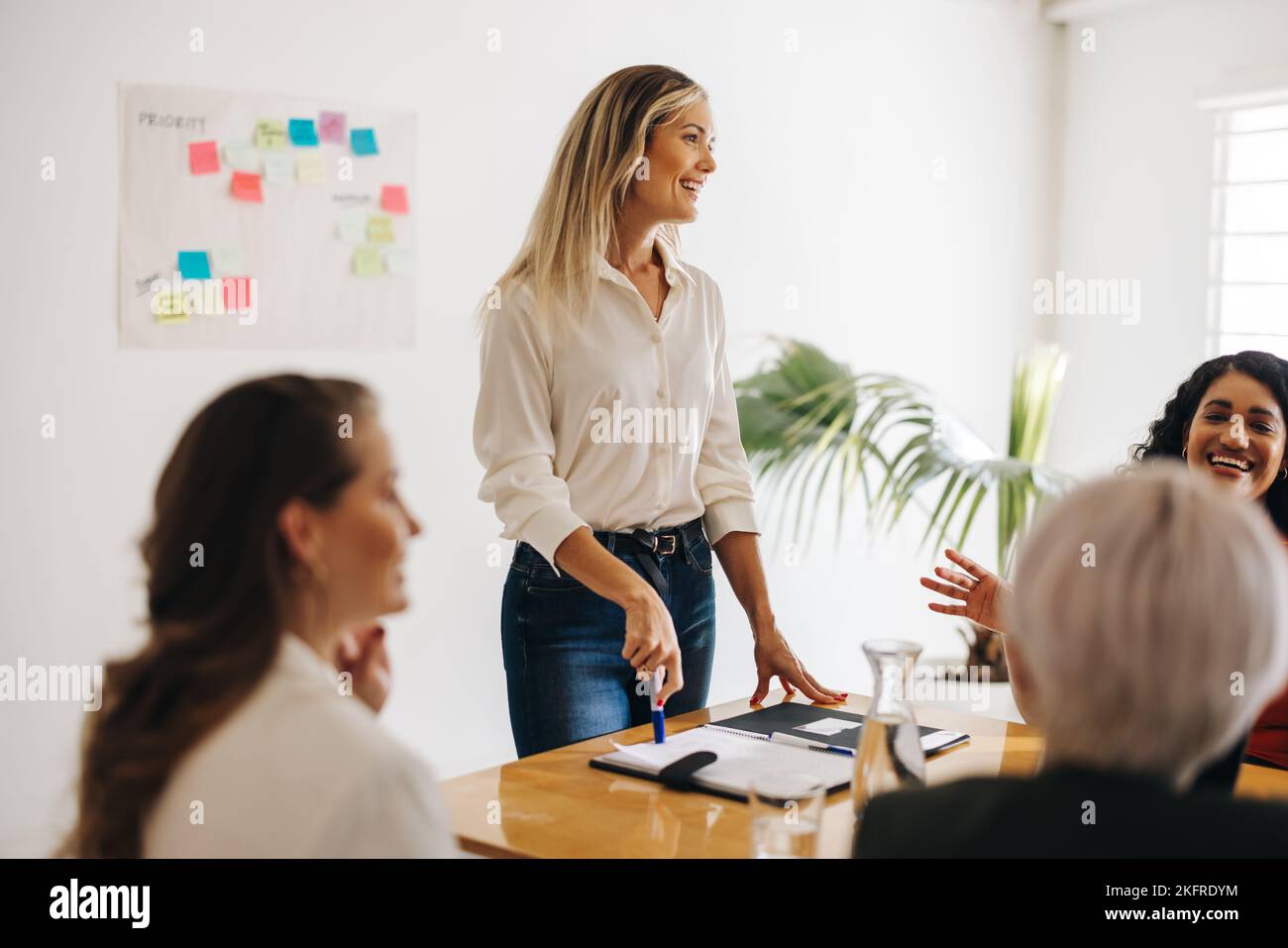 Successful businesswomen having a discussion during a meeting. Group of diverse businesswomen brainstorming in a boardroom. Happy businesswomen workin Stock Photo