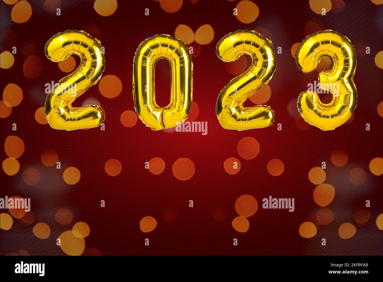 New Year 2023 celebration. Golden Yellow foil color balloons. 2023 balloons. On red background Stock Photo