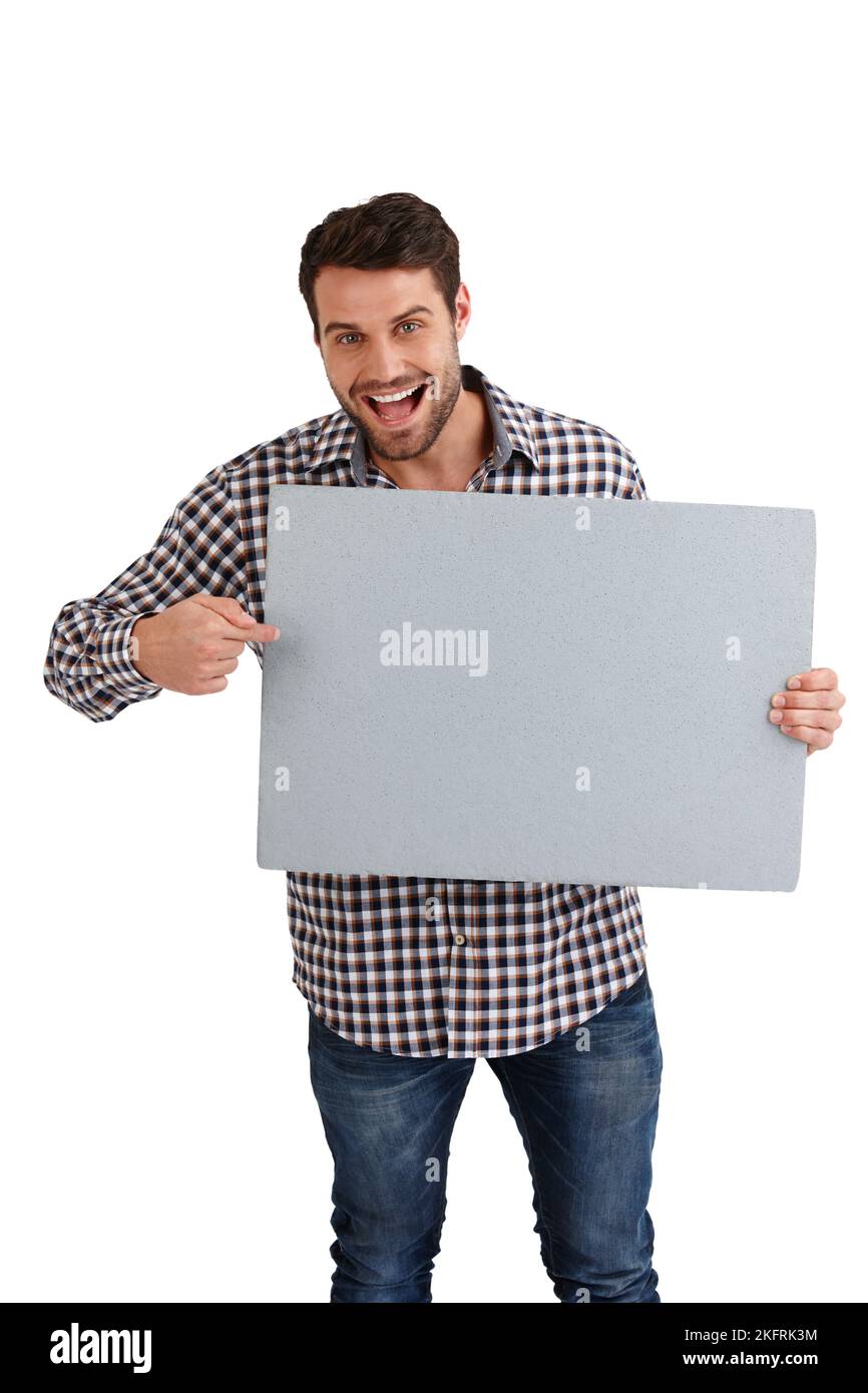 Hes getting excited about your ad. Studio portrait of a handsome young man pointing to the blank placard hes holding isolated on white. Stock Photo