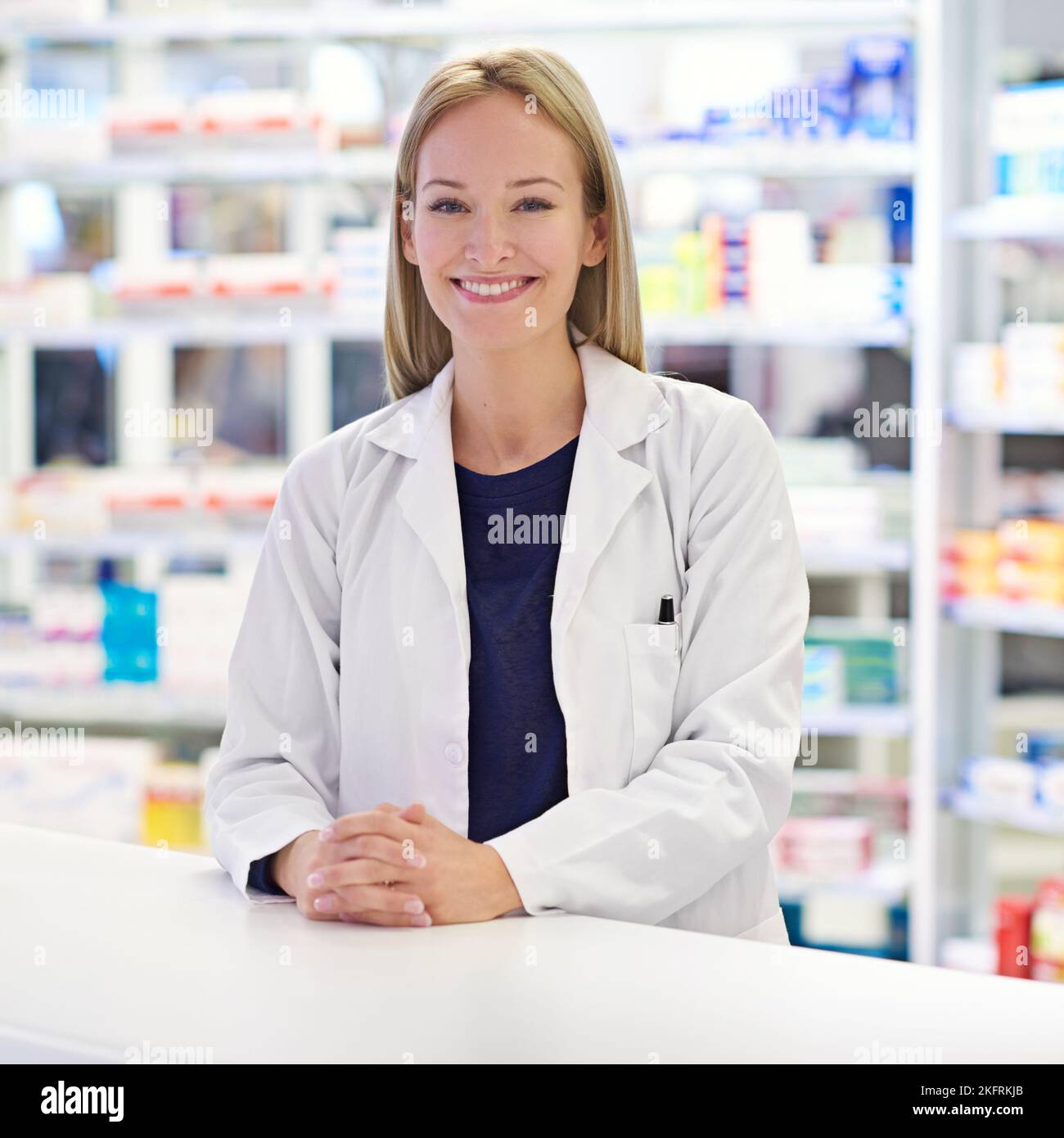 You friendly neighborhood pharmacist. Portrait of an attractive pharmacist standing at the prescription counter. Stock Photo