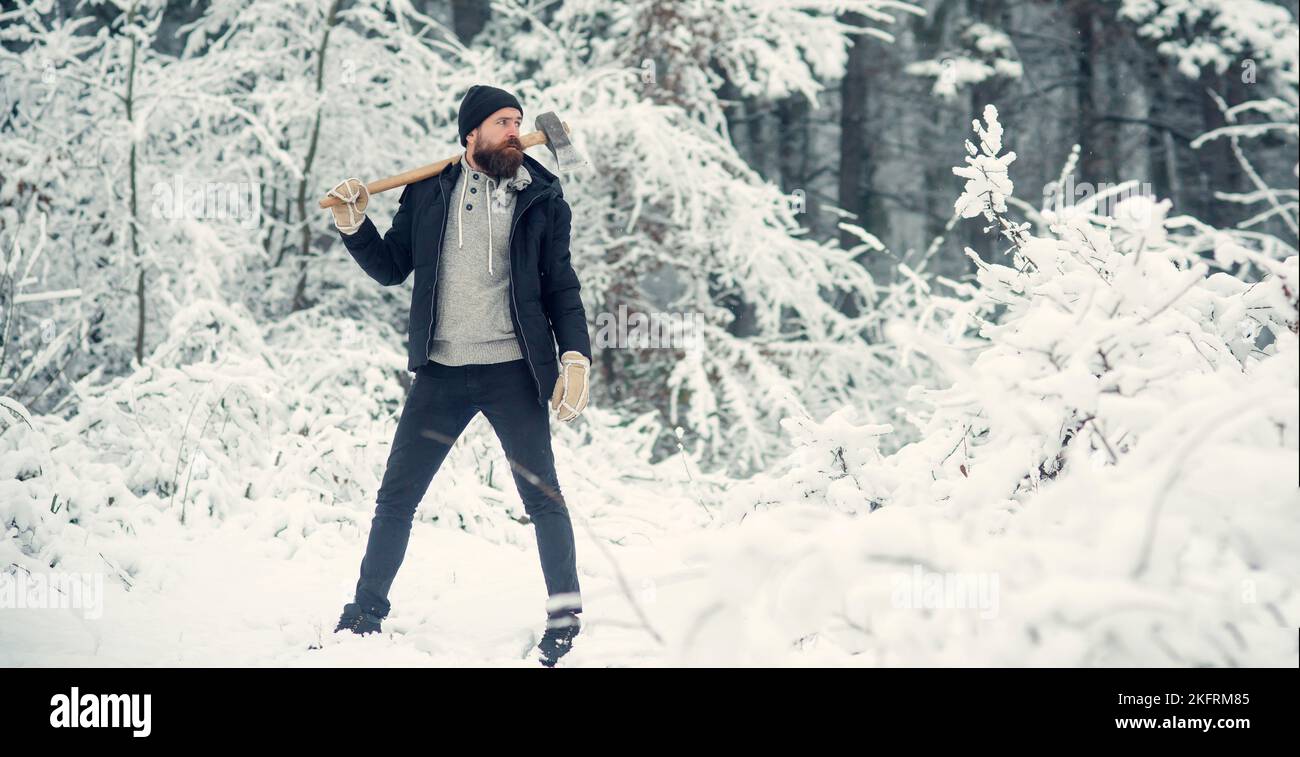 Lumberjack holds axe. Hipster with beard on serious face with axe