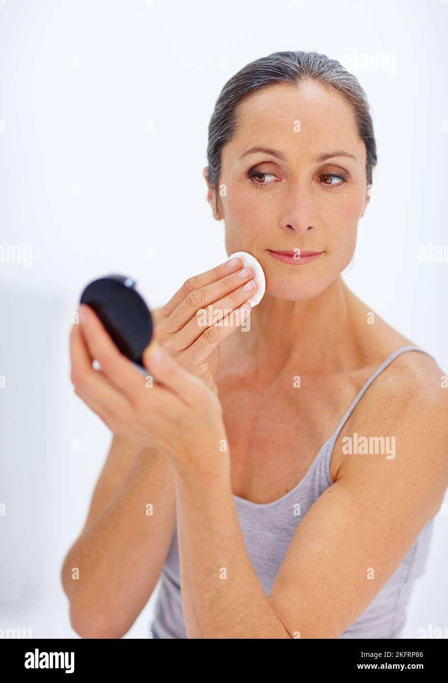 Keeping her skin fresh and blemish-free. an attractive mature woman taking care of her skin 