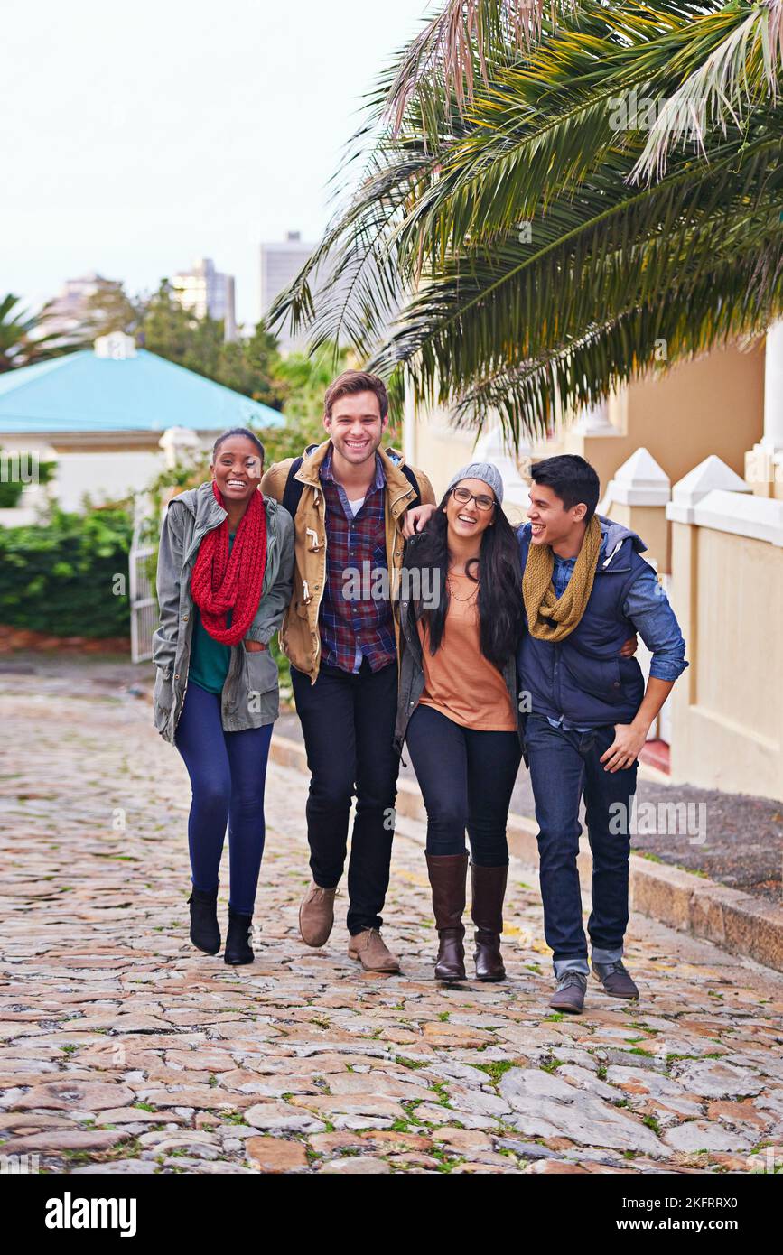 Campus buddies. a group of college students walking together on campus