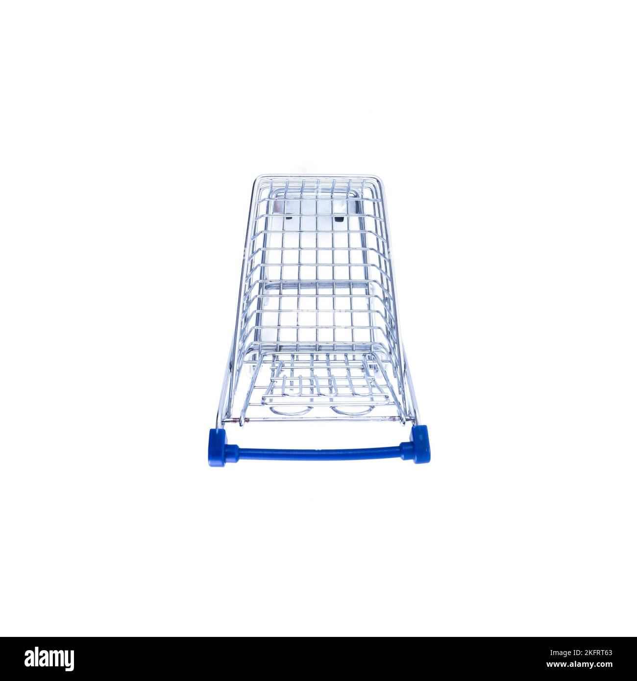 empty shopping cart over white background, mini metal cart isolated on color background Stock Photo