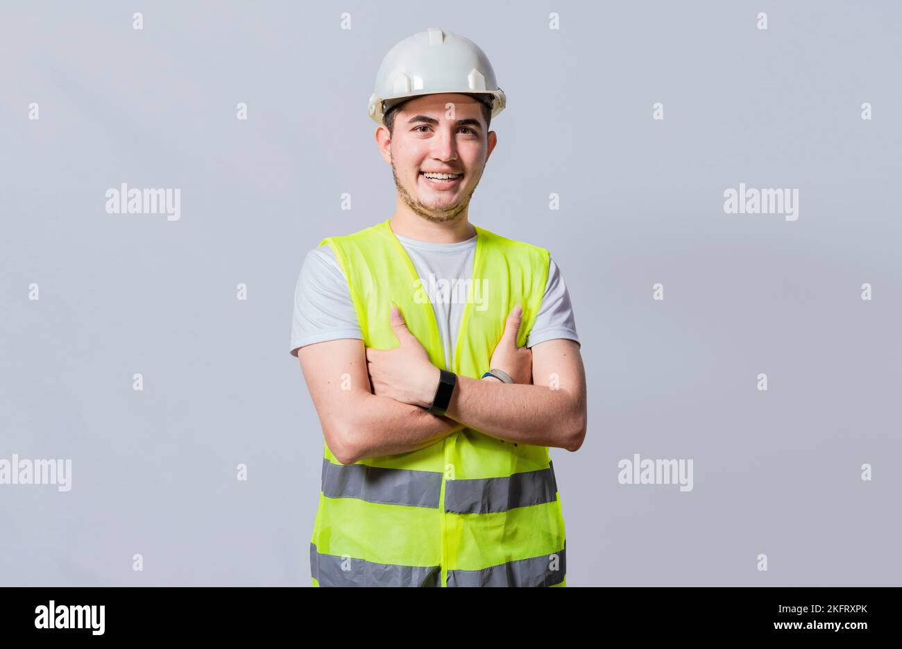 Portrait of smiling handsome engineer on white background, Portrait of young engineer wearing