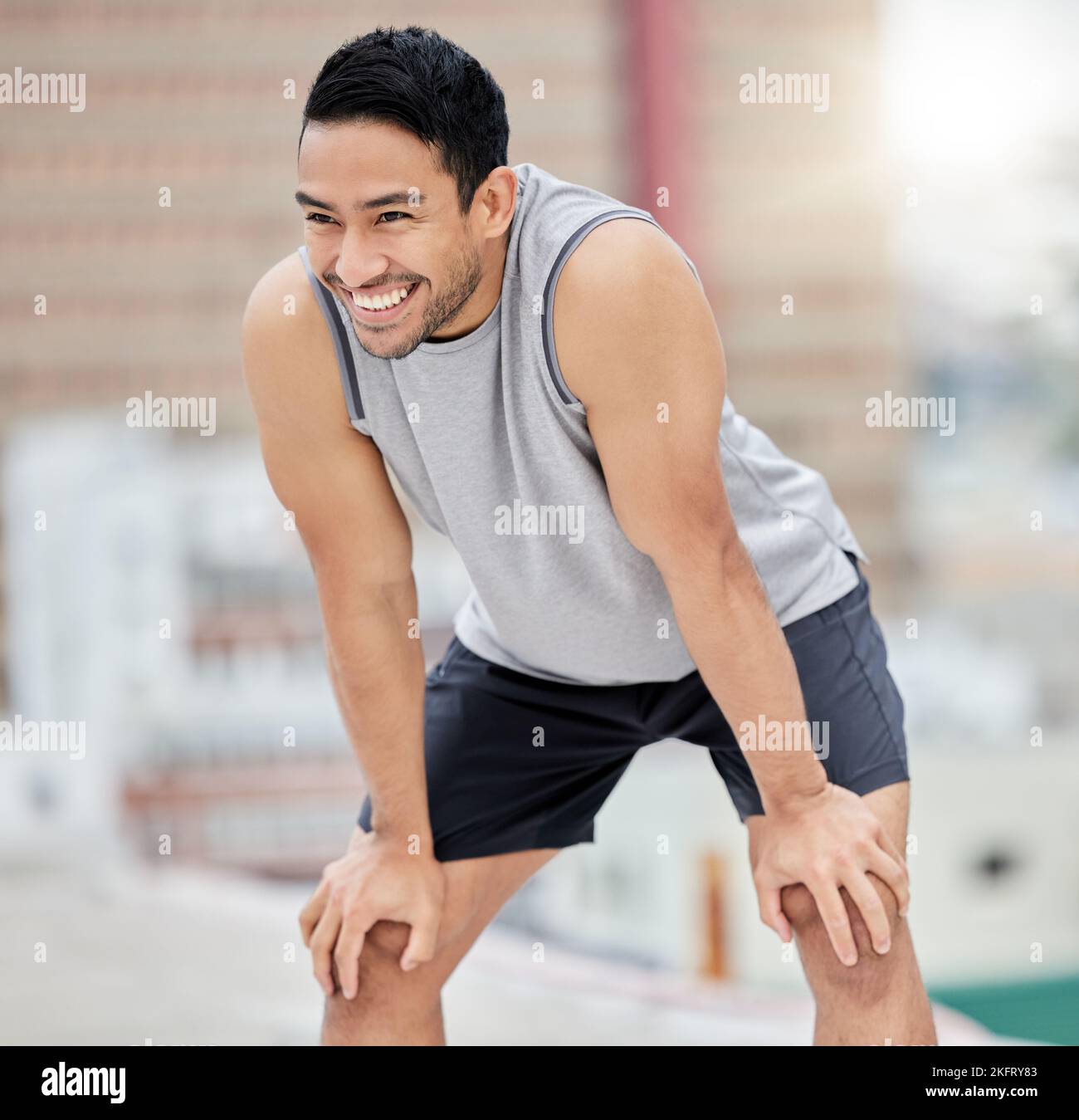 Fitness break, rest and happy man, city exercise and workout and motivation for fitness, body training and healthy lifestyle outdoors. Smile, tired Stock Photo
