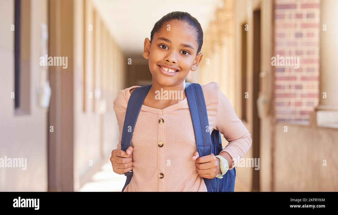 Happy, school girl and portrait smile with backpack for learning, education or childhood development at academy. Female teenager smiling for school Stock Photo