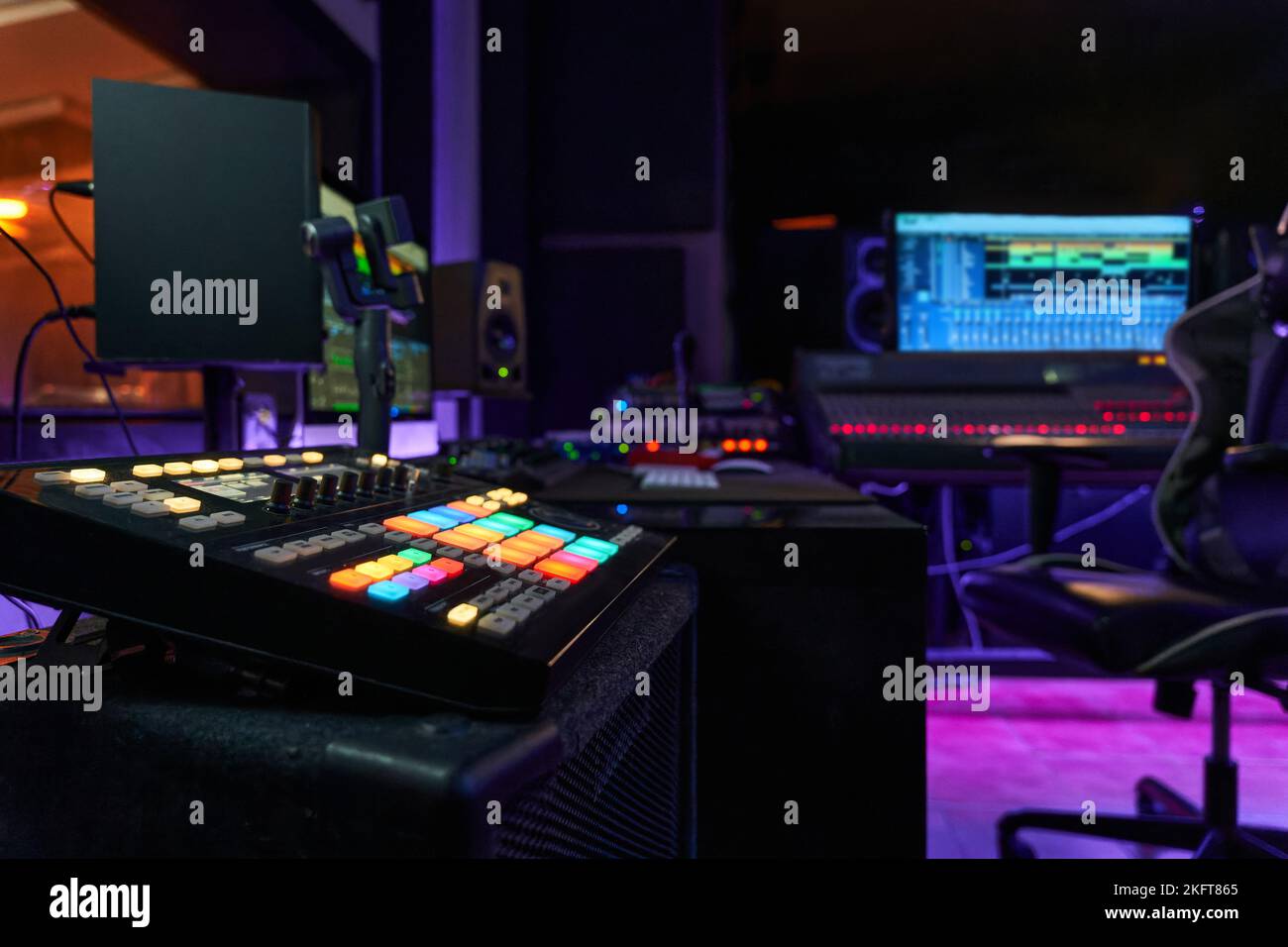 Contemporary recording studio with glowing neon lights and ring lamp