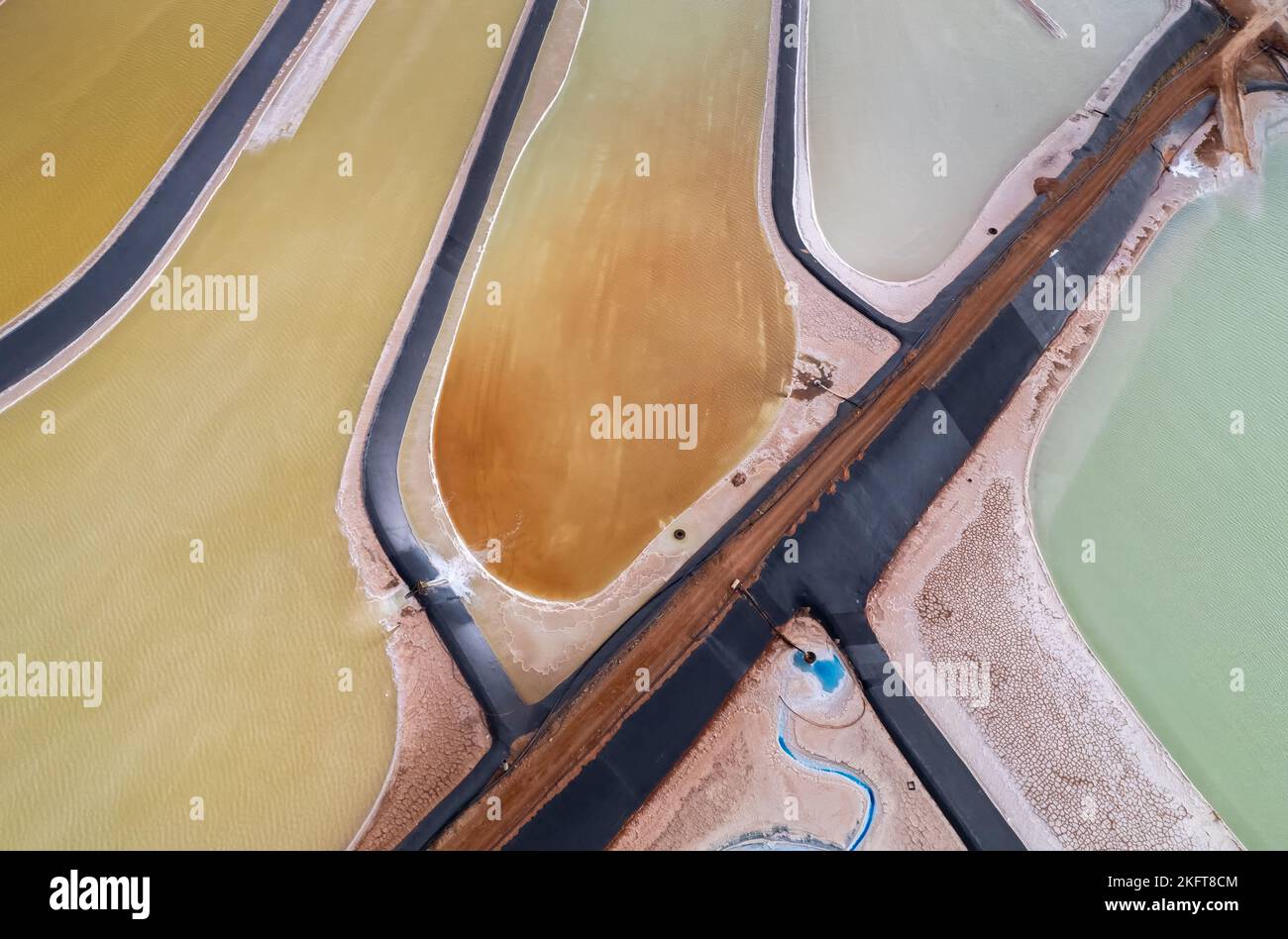 From above aerial view of straight road located near brine evaporation
