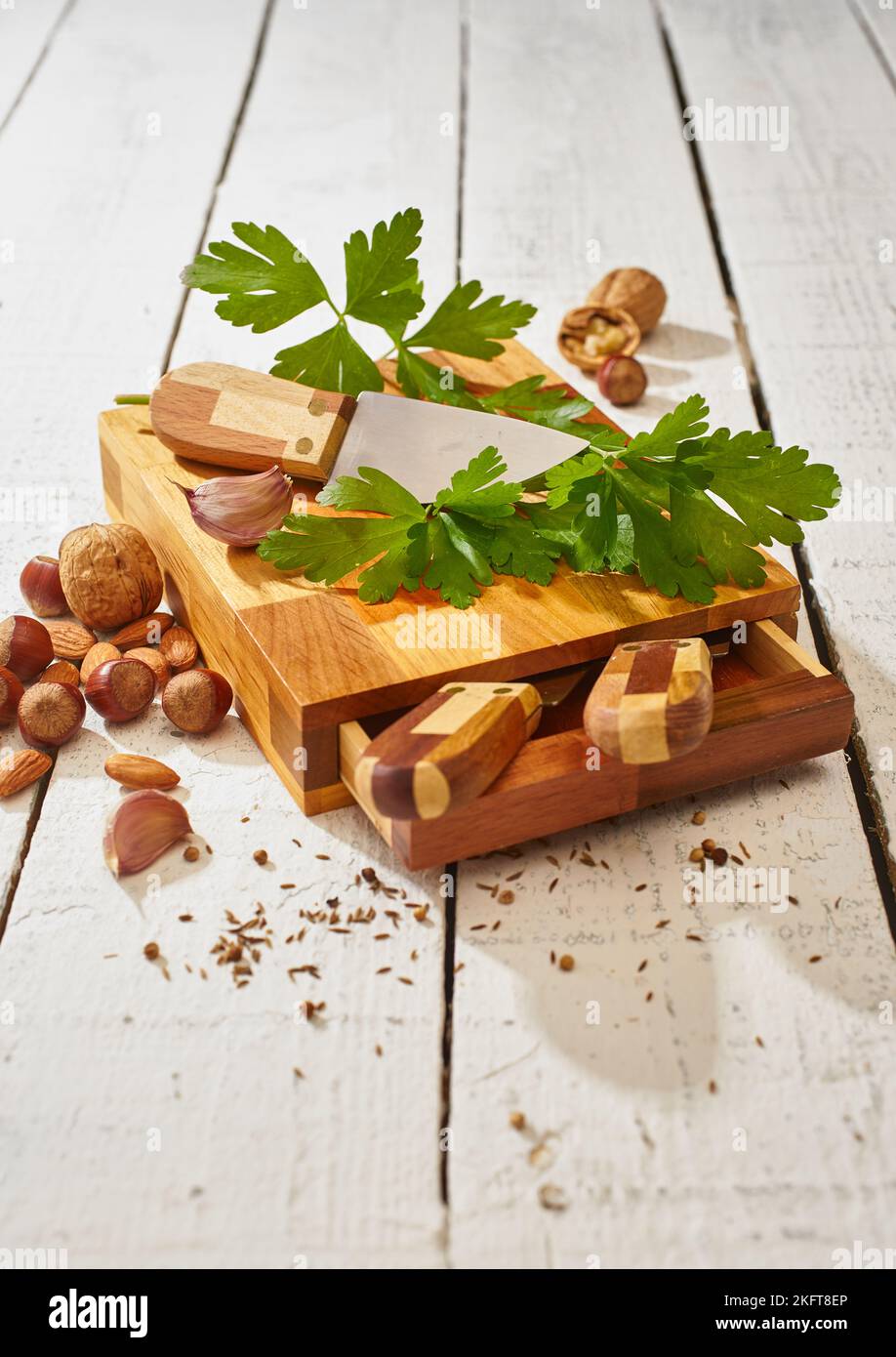 Ripe green parsley and sharp knife on wooden cutting board set Stock Photo
