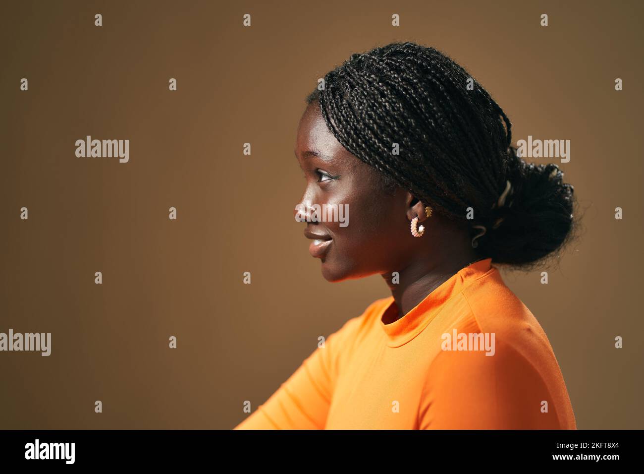 Side view portrait of smiling young African American female with Afro ...