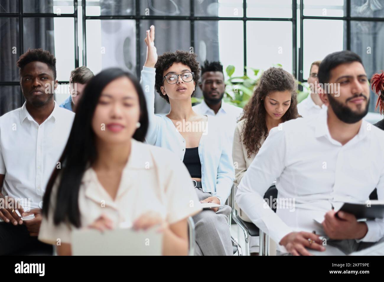 conducts business training with a group of young people. Stock Photo