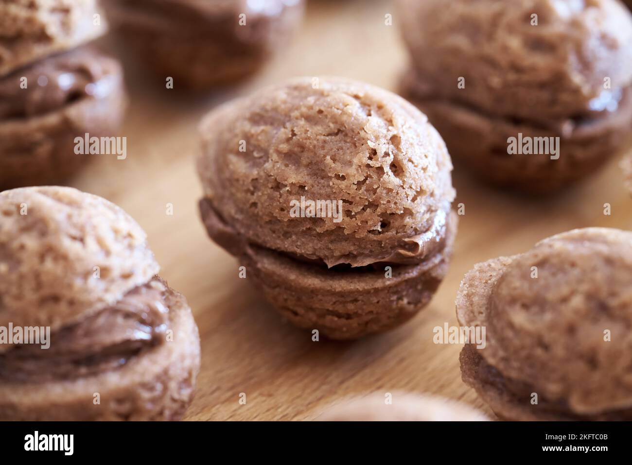 https://c8.alamy.com/comp/2KFTC0B/homemade-christmas-cocoa-cookies-in-the-form-of-nuts-filled-with-chocolate-cream-close-up-2KFTC0B.jpg